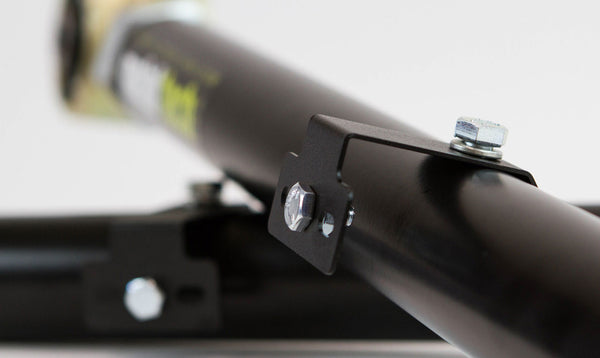 Close-up of black metal rear link with mounting bracket and bolts for FJ Cruiser and 4Runner suspension upgrade.