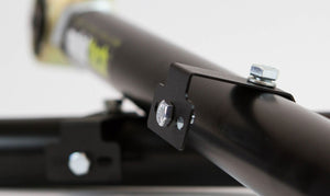 Close-up of black metal offset rear lower link with mounting bracket and bolts for Lexus GX470/GX460 suspension.