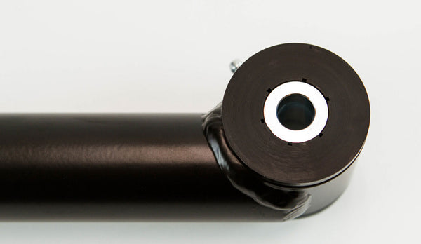 Close-up of black metal rear lower link with bushing for FJ Cruiser and 4Runner suspension upgrade.