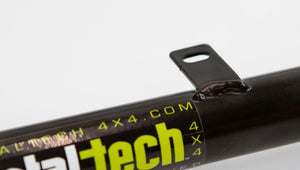 Close-up of black Metal Tech 4x4 rear link tube with mounting tab and yellow logo decal.