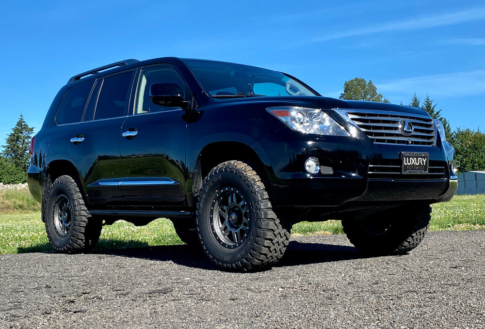 Black metal rock sliders and mounting brackets for Lexus LX570, laid out on a white background.