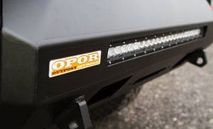 Close-up of black MetalTech 4x4 Stronghold winch bumper with integrated LED light bar and OPOR sticker.