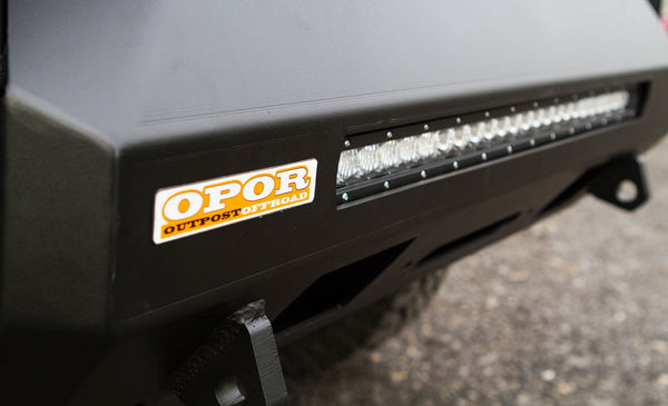 Close-up of black MetalTech 4x4 Stronghold winch bumper with integrated LED light bar and OPOR sticker.
