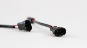 Close-up of black OEM-style fog light harness connectors for 2010 Toyota 4Runner, Tundra, and Tacoma.