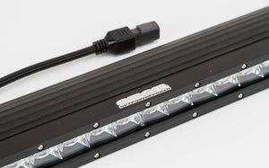 Close-up of a black 120W single-row LED light bar with clear lenses and attached power harness on white background.