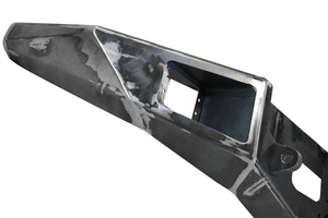 Raw metal front bumper for FJ Cruiser with cutouts and mounting points, angled view.
