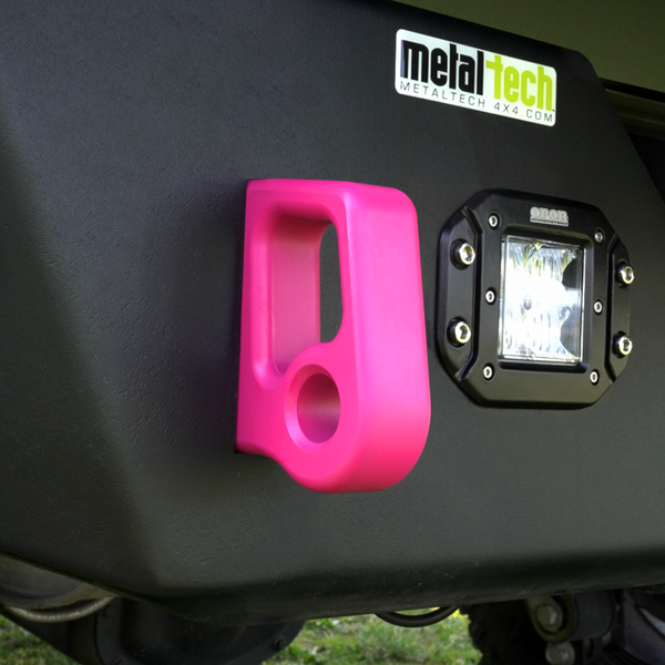 Close-up of bright pink aluminum rear bumper pull point with Cerakote finish installed on black bumper.