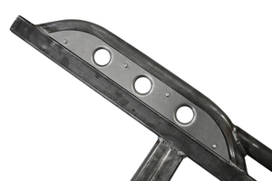 Close-up of raw steel 2021 Bronco 4-door Sidewinder rock slider with three circular cutouts and welds.