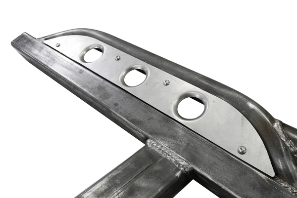 Close-up of raw steel 2021 Bronco 4-door Sidewinder rock slider with three circular cutouts on white background.