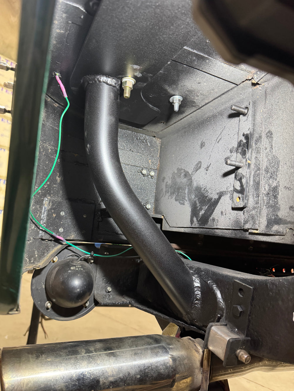 Metal Tech FJ40 Land Cruiser rear roll cage frame tie kit parts laid out on a brown surface.