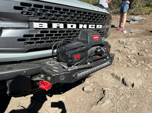 Close-up of Bronco 6G Stronghold winch mount installed on front bumper with Warn VR Evo winch and synthetic rope.