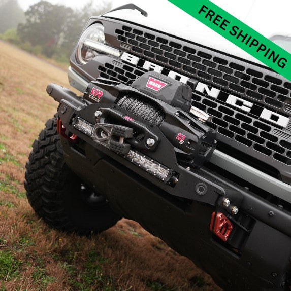 Close-up of Bronco 6G Stronghold winch mount installed on front bumper with Warn VR EVO winch and LED light bar.