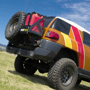 Rear view of FJ Cruiser with Metal Tech Red Eye II full shell swing-out bumper and mounted spare tire and fuel can.