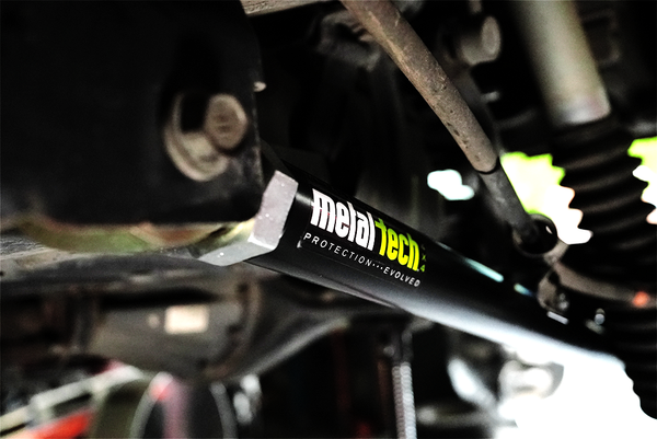 Close-up of Metal Tech 4x4 rear upper link installed on FJ Cruiser or 4Runner suspension system.