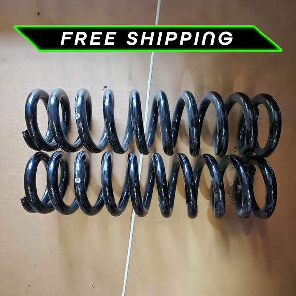 Pair of black 600lb coil springs for 2003-2019 Toyota 4Runner laid flat on cardboard surface.
