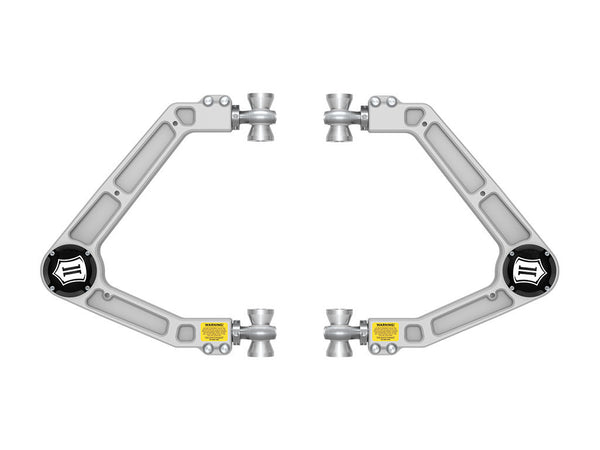 Pair of silver billet upper control arms for 2024 Land Cruiser 250 Series with adjustable joints and warning labels.