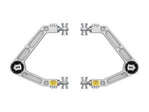 Pair of silver billet upper control arms for 2024 Land Cruiser 250 Series with black caps and yellow warning labels.