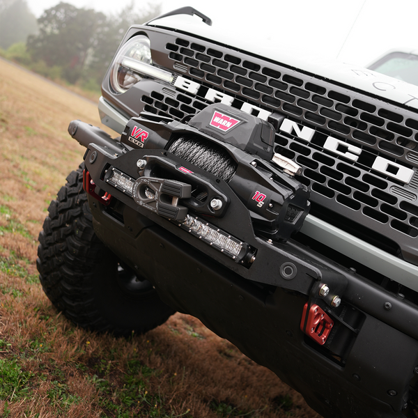 Front close-up of Bronco 6G with black Stronghold winch mount and Warn VR EVO winch installed on bumper.